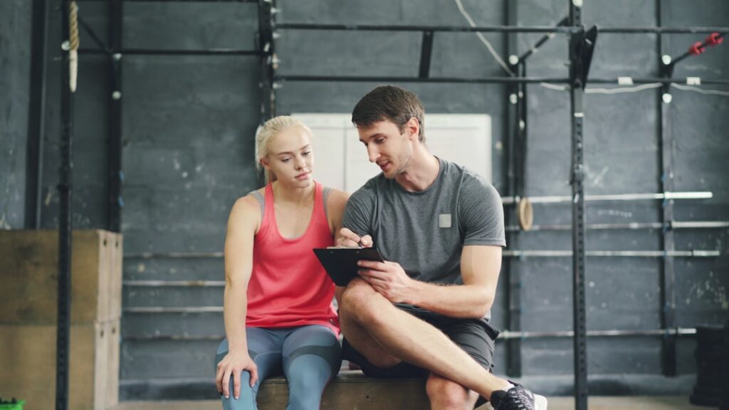 Sports psychologist discussing mental performance strategy with an Indian athlete