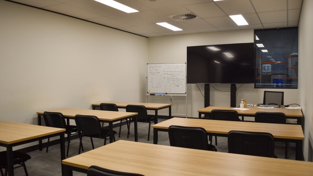 Students discussing sports education and career paths in a modern classroom