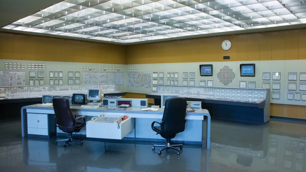 Sports management professional overseeing stadium operations in a control room