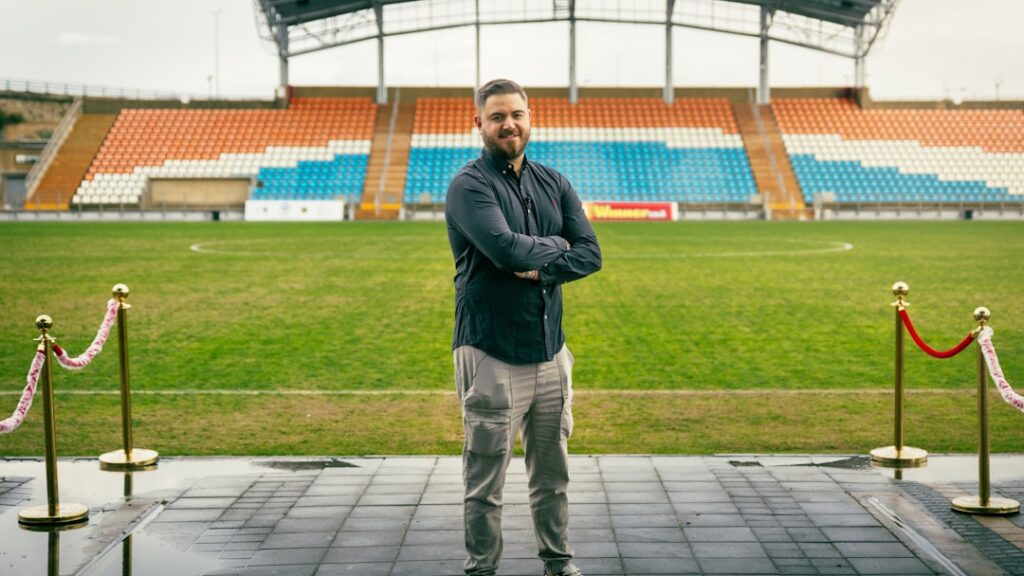 A sports management professional managing an event at a stadium