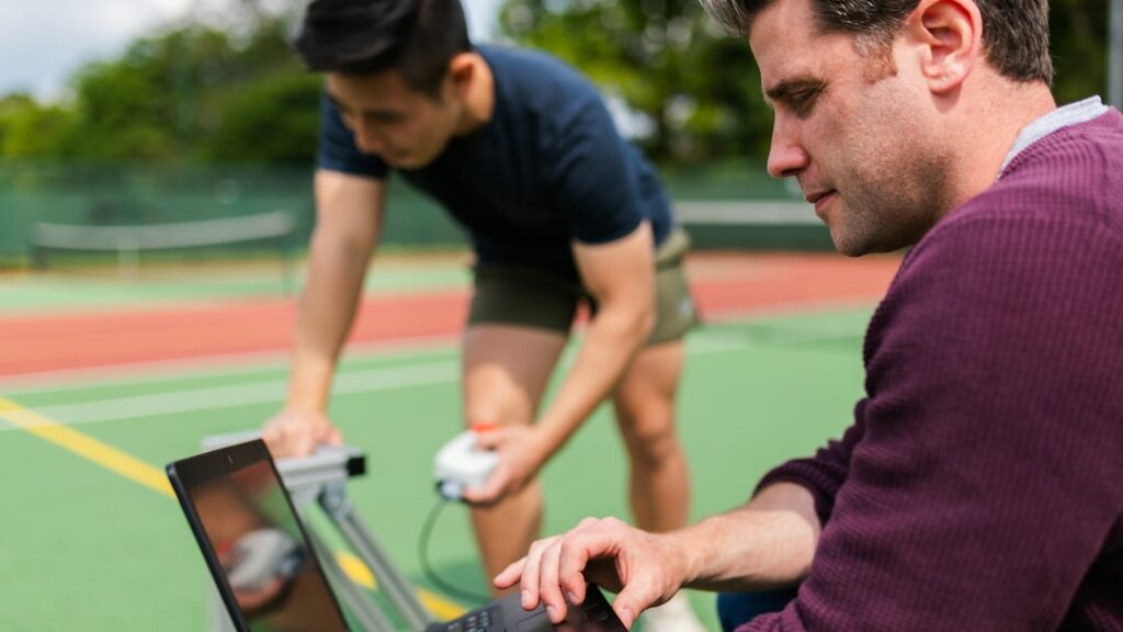 Sports scientist analyzing athlete performance data using a tablet