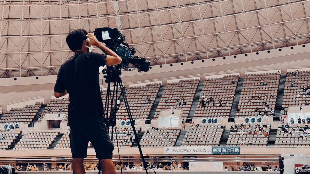 High-definition television broadcast cameras covering an elite stadium match representing the richest sports leagues in the world
